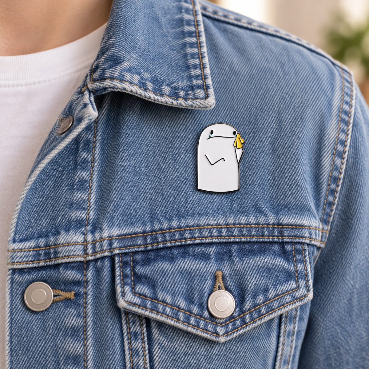 AI-styled wearing view of Crying Character with Yellow Tissue Pin on medium-blue denim jacket being worn by an adult