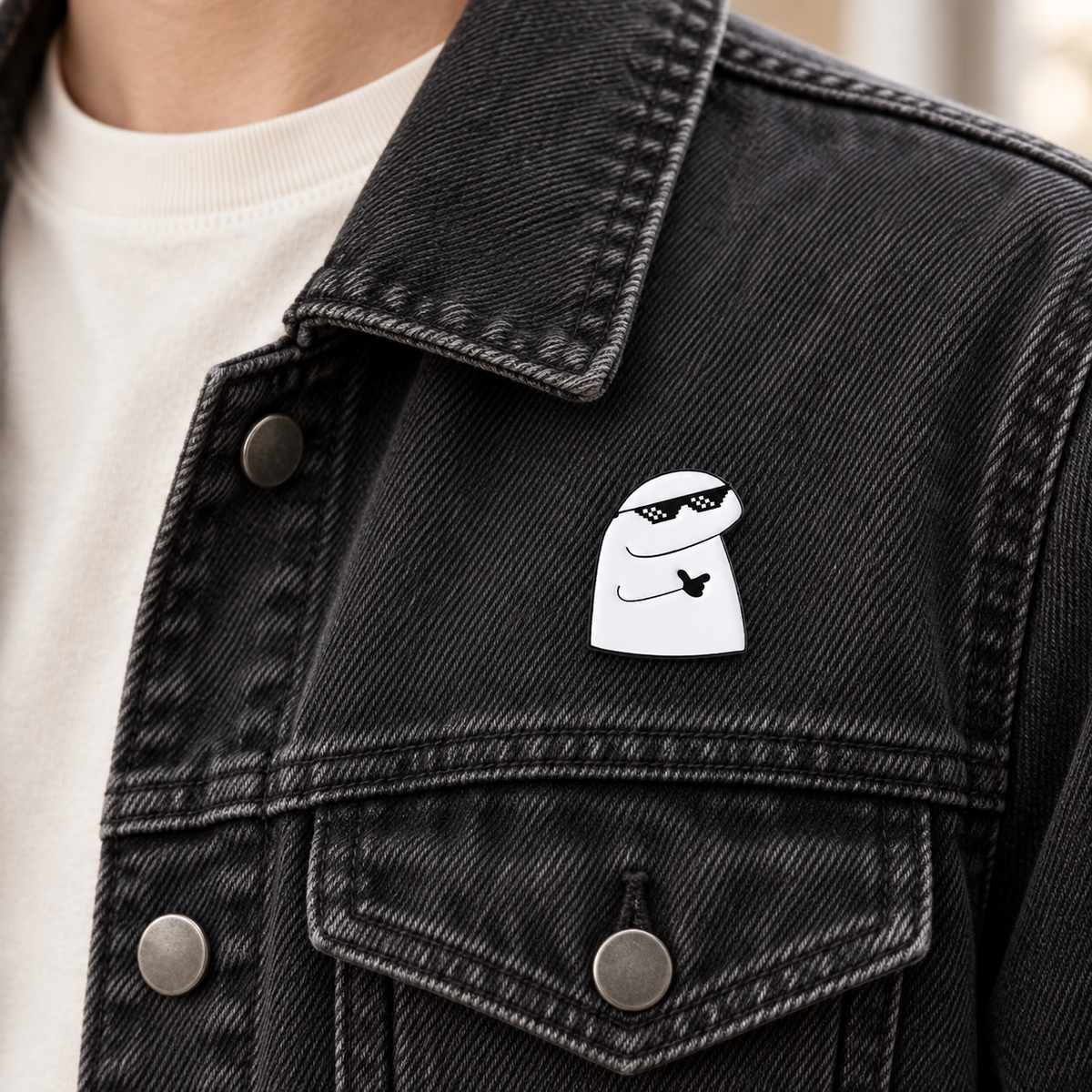 AI-styled wearing view of Pixel Sunglasses Character Pin on charcoal-black denim jacket being worn by an adult
