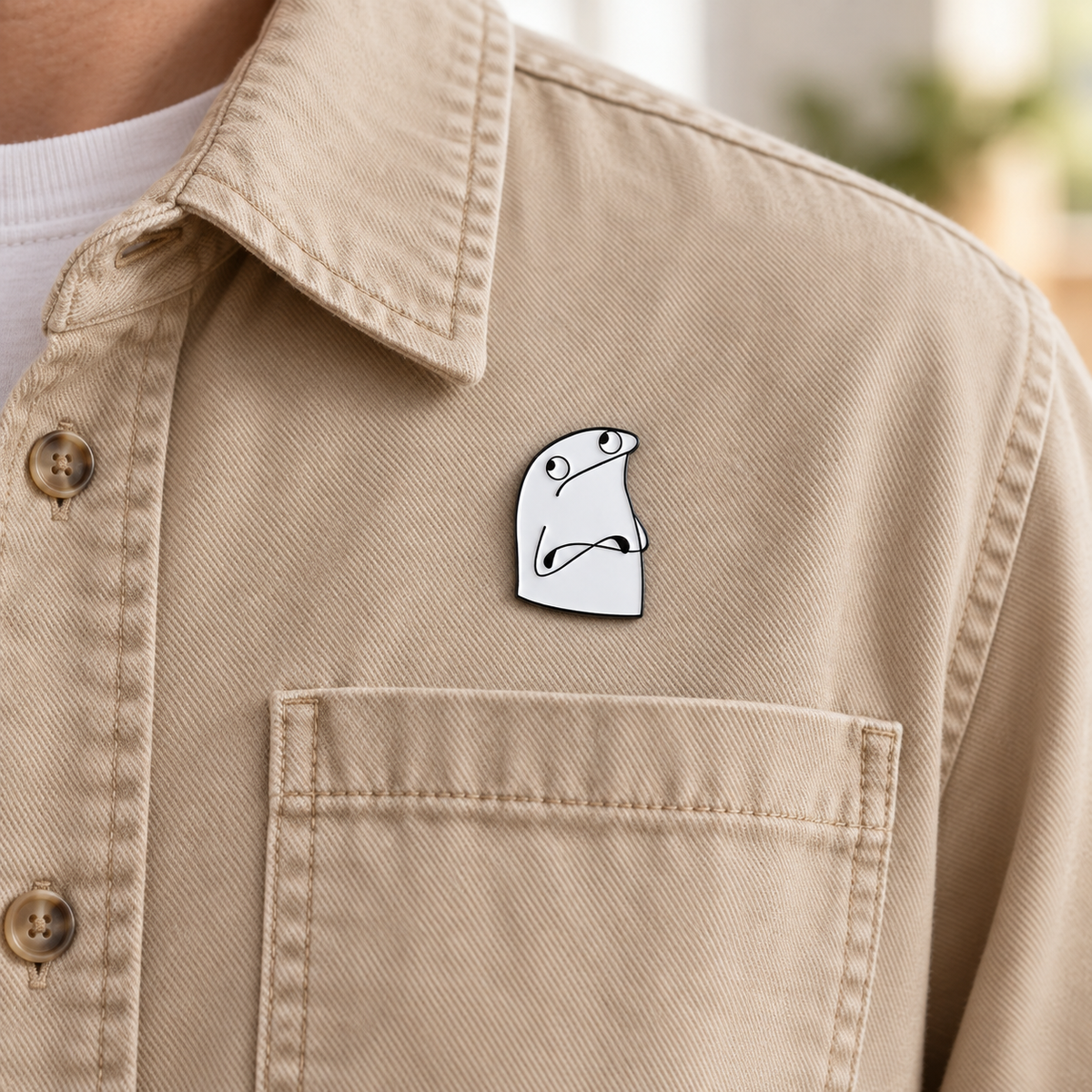 AI-styled wearing view of Side-Eye Crossed Arms Character Pin on sand-colored cotton overshirt being worn by an adult