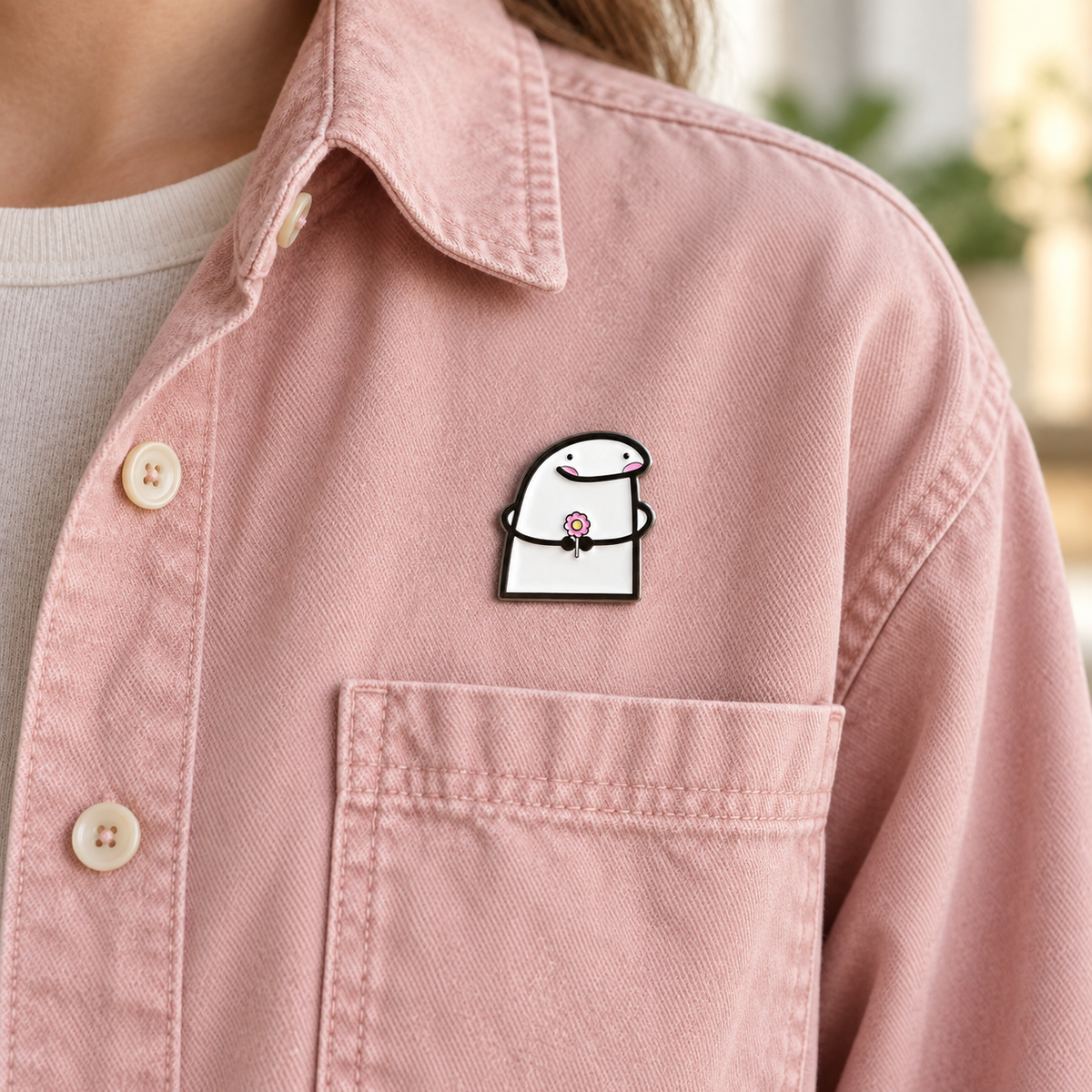 AI-styled wearing view of Smiling Character Holding Flower Pin on dusty blush pink cotton overshirt being worn by an adult