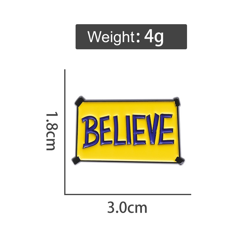 Yellow rectangular sign with large blue Believe lettering, enamel pin on pale blue