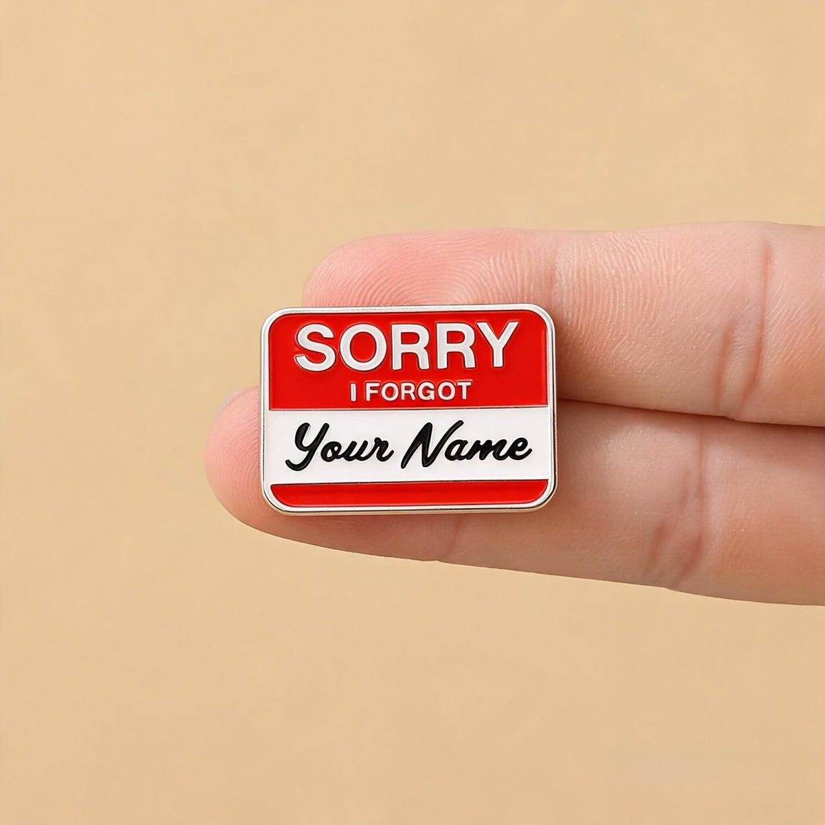 Sorry I Forgot Your Name Enamel Pin held between fingers for scale