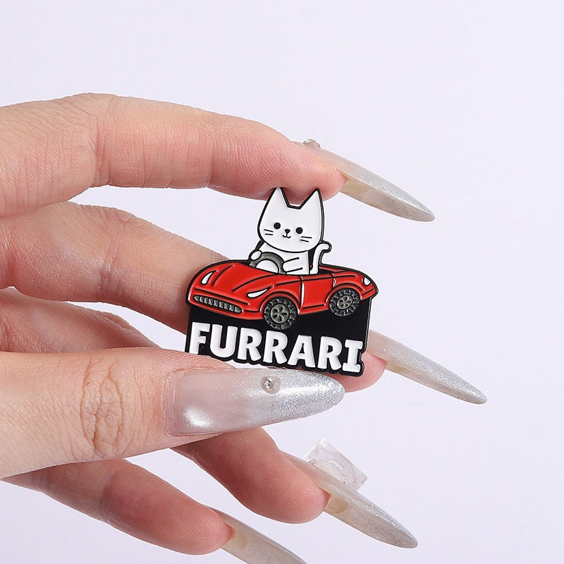 Furrari Cat in Red Sports Car Enamel Pin held between fingers for scale