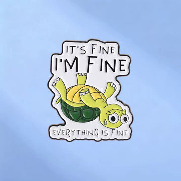 Upside-down green turtle enamel pin reading It's Fine I'm Fine Everything Is Fine on blue