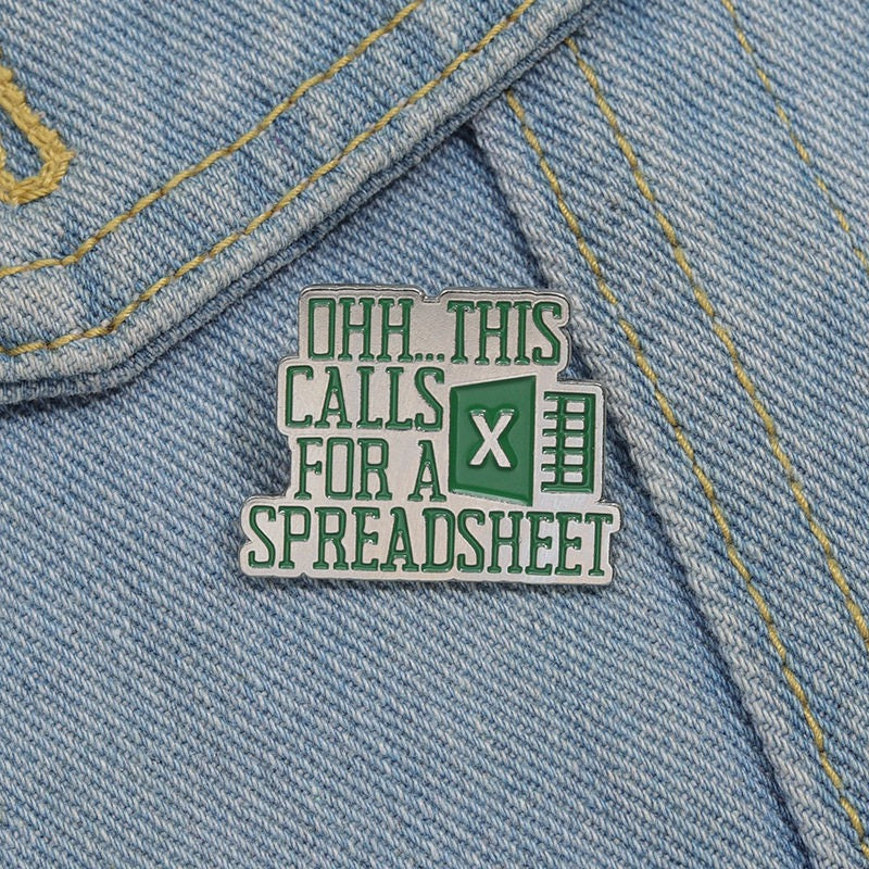 This Calls for a Spreadsheet enamel pin on light denim